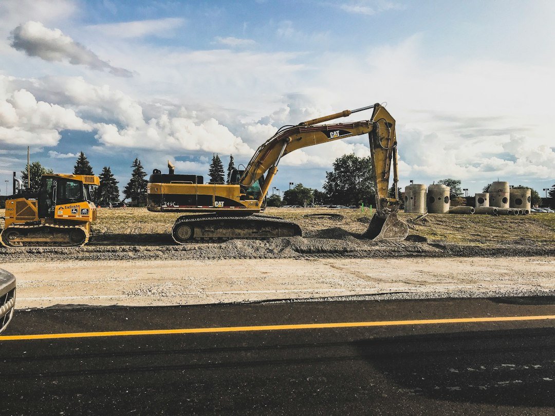 Services yellow-caterpillar-excavator-digging-up-dirt-zgmgq-efmus